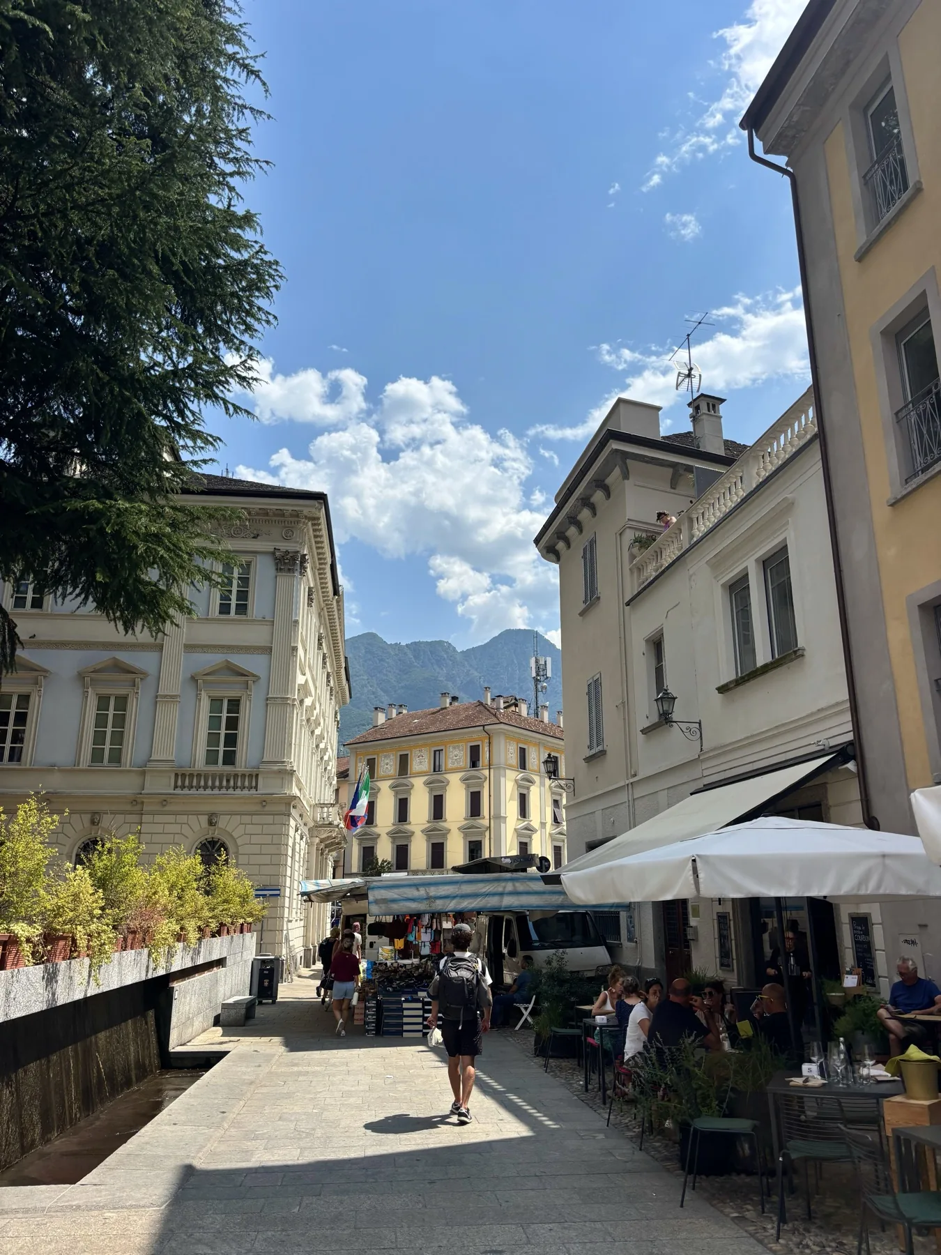 A sunny border town with mountains in the distance